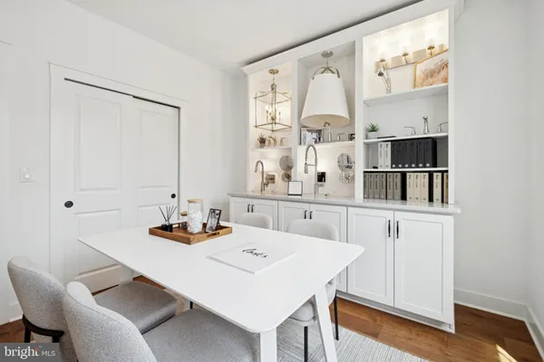 a dining room with furniture and wooden floor