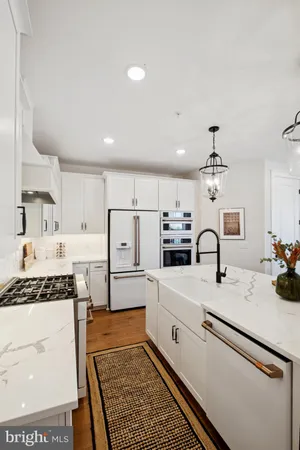 a kitchen with a sink stove and white cabinets