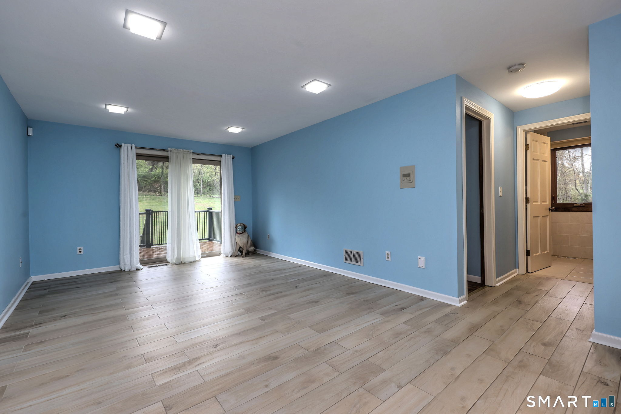 2262 Ridge Road North Haven, CT 06473 - Photo 13 of 40 a view of an empty room with wooden floor and a window