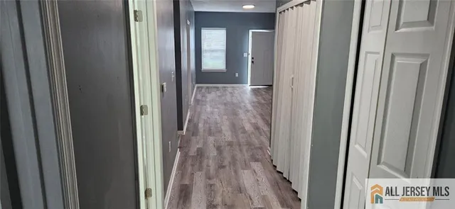a view of a hallway with wooden floor