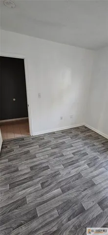 a view of room with wooden floor