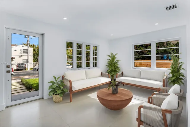 a living room with furniture and a potted plant