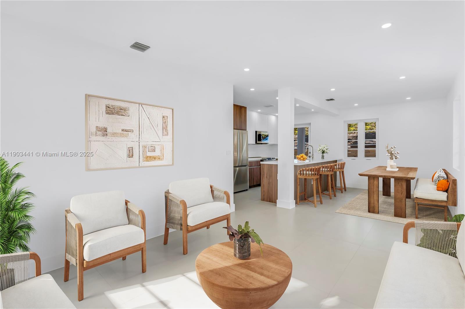 524 Northeast 65th Street, Unit 1 Miami, FL 33138 - Photo 6 of 26 a living room with furniture and a view of kitchen