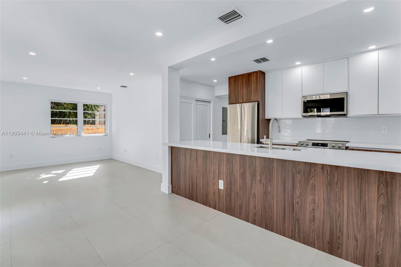 524 Northeast 65th Street, Unit 1 Miami, FL 33138 - Photo 8 of 26 a kitchen with stainless steel appliances a refrigerator sink and microwave