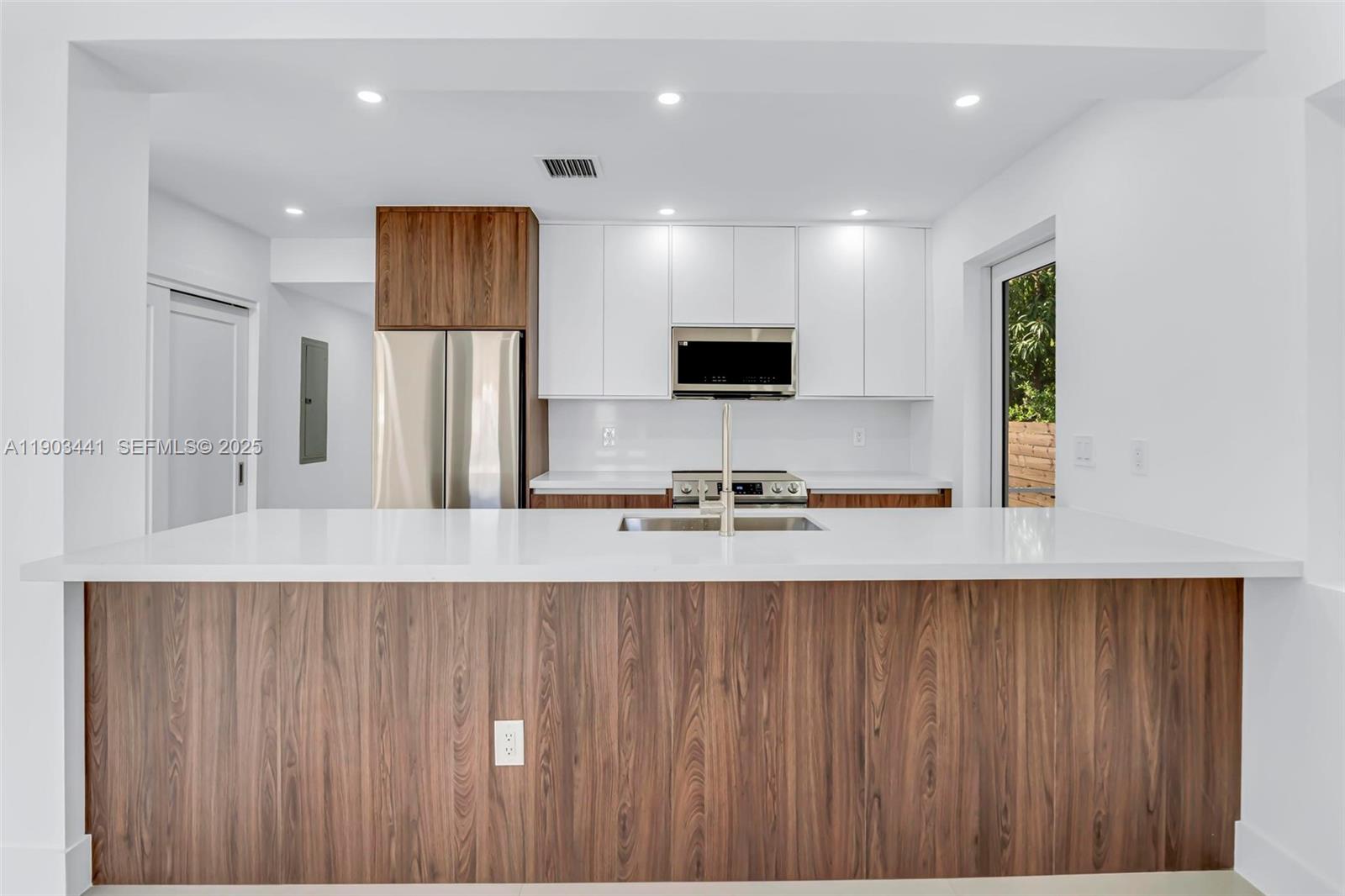 524 Northeast 65th Street, Unit 1 Miami, FL 33138 - Photo 9 of 26 a large kitchen with a large window and stainless steel appliances