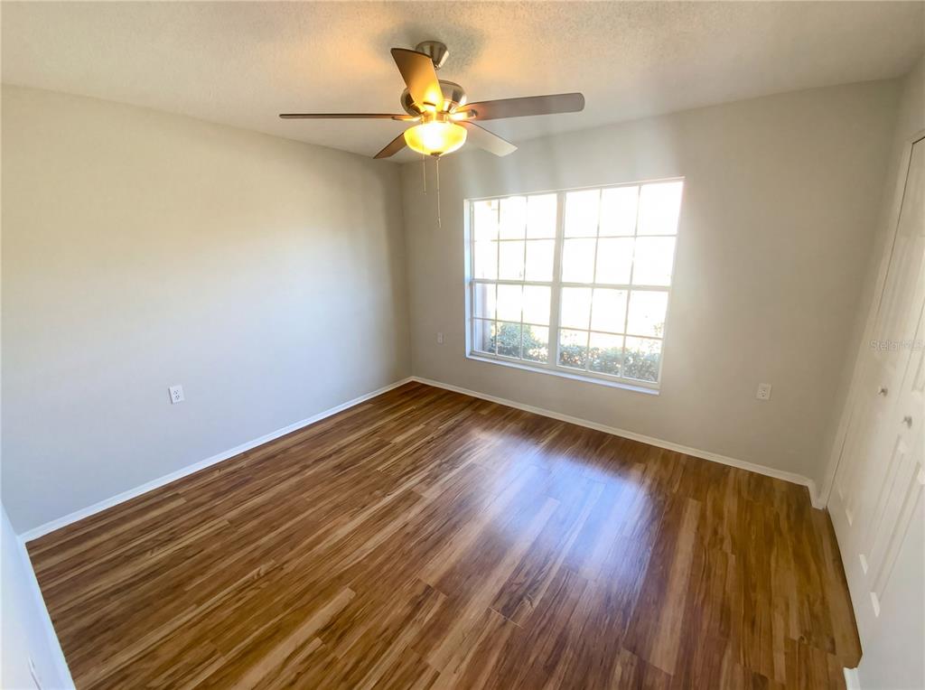 7410 Willowbrook Drive Spring Hill, FL 34606 - Photo 12 of 23 wooden floor in an empty room with a window