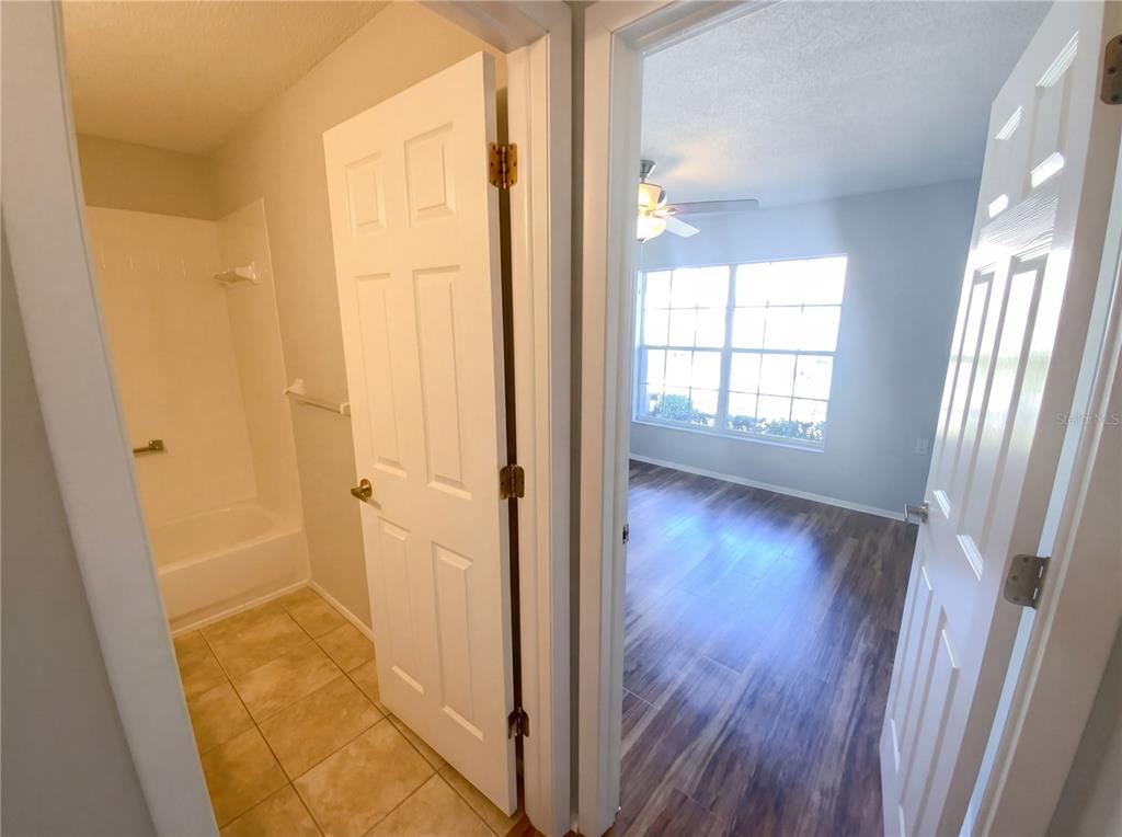 7410 Willowbrook Drive Spring Hill, FL 34606 - Photo 13 of 23 a view of a hallway with wooden floor and cabinet
