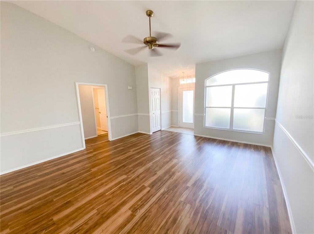 7410 Willowbrook Drive Spring Hill, FL 34606 - Photo 14 of 23 wooden floor in an empty room with a window