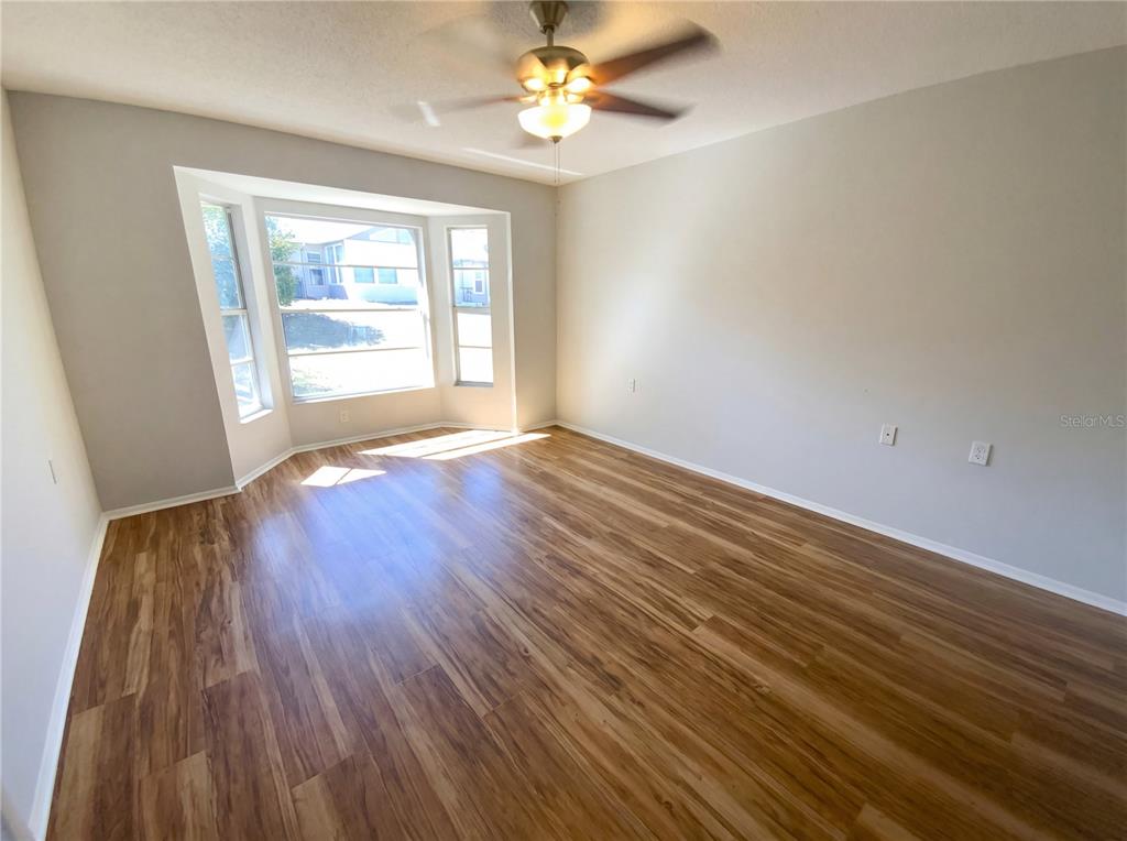 7410 Willowbrook Drive Spring Hill, FL 34606 - Photo 15 of 23 wooden floor in an empty room with a window
