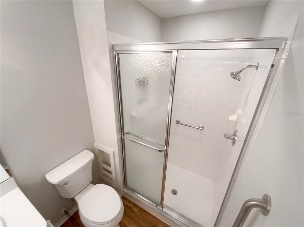 7410 Willowbrook Drive Spring Hill, FL 34606 - Photo 17 of 23 a white toilet sitting next to a shower