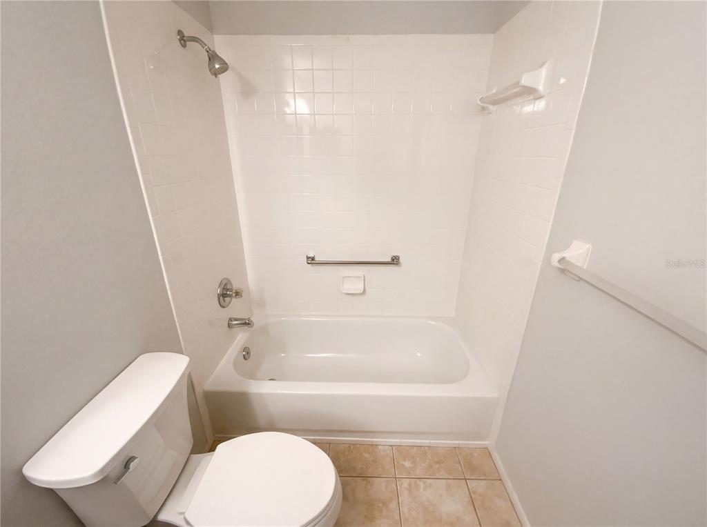 7410 Willowbrook Drive Spring Hill, FL 34606 - Photo 19 of 23 a bathroom with a toilet and a bath tub
