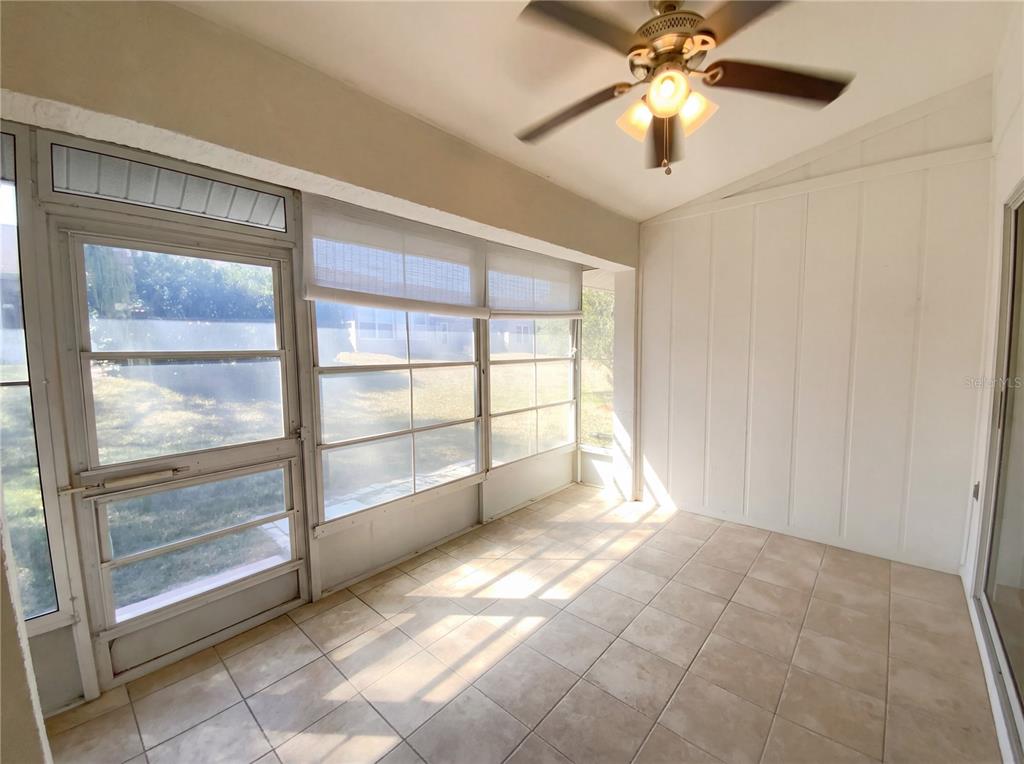 7410 Willowbrook Drive Spring Hill, FL 34606 - Photo 22 of 23 a view of a livingroom with a ceiling fan and window