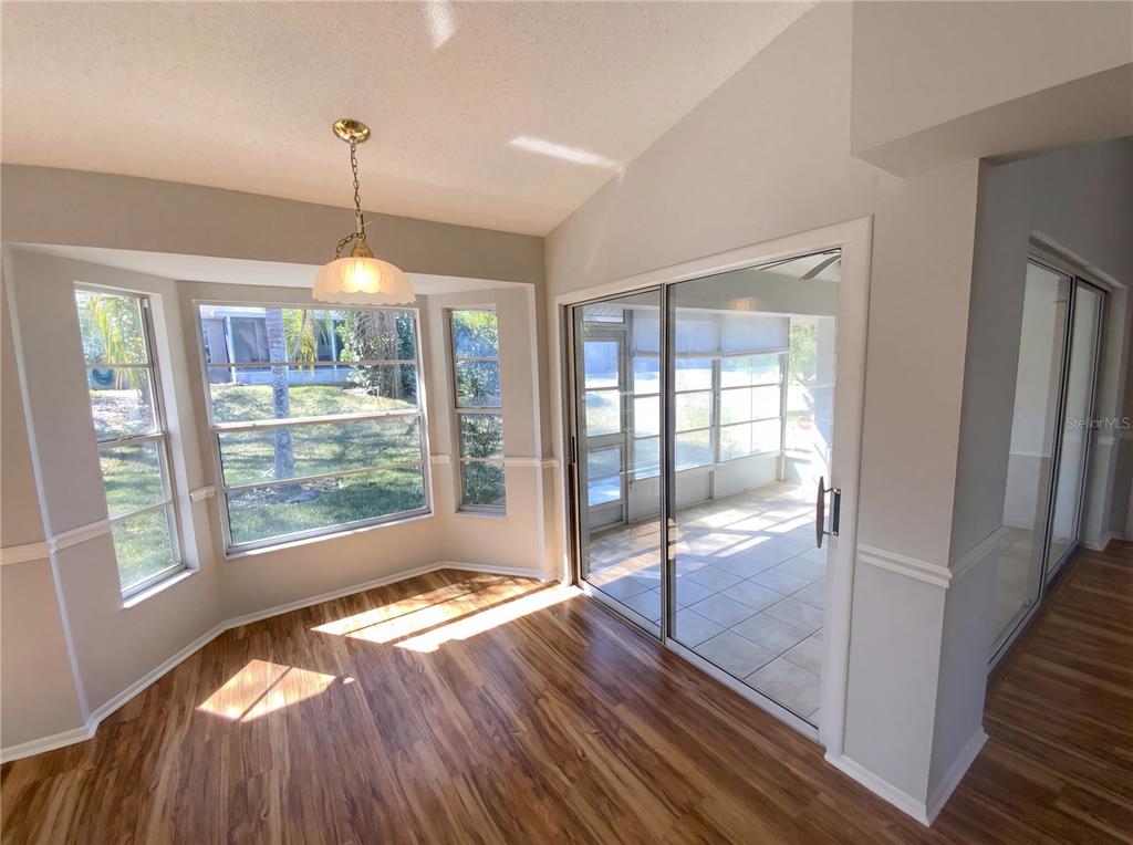 7410 Willowbrook Drive Spring Hill, FL 34606 - Photo 3 of 23 a view of an empty room with wooden floor and a window