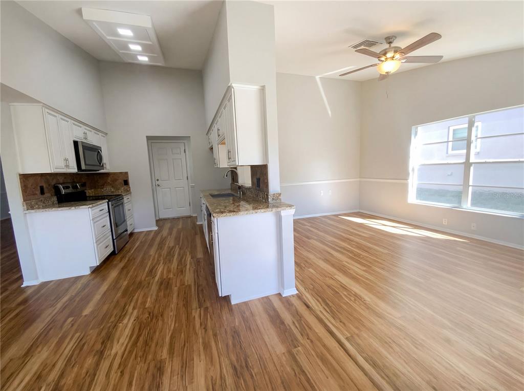 7410 Willowbrook Drive Spring Hill, FL 34606 - Photo 4 of 23 a view of a kitchen with wooden floor and a sink