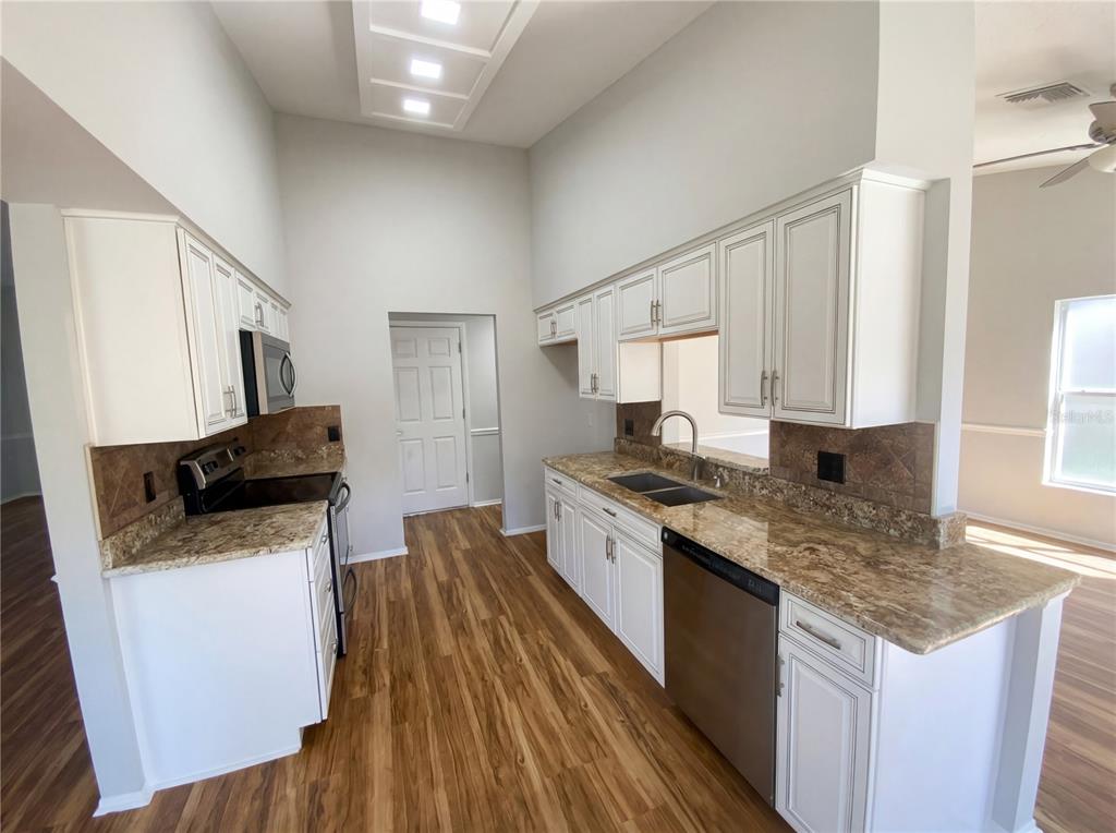7410 Willowbrook Drive Spring Hill, FL 34606 - Photo 5 of 23 a kitchen with a sink stove and refrigerator