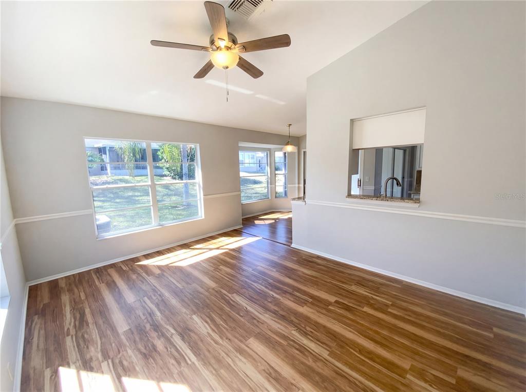 7410 Willowbrook Drive Spring Hill, FL 34606 - Photo 9 of 23 a view of an empty room with wooden floor and a window