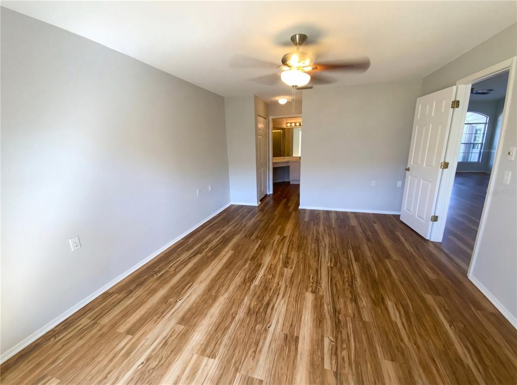 7410 Willowbrook Drive Spring Hill, FL 34606 - Photo 10 of 23 a view of a room with wooden floor and staircase