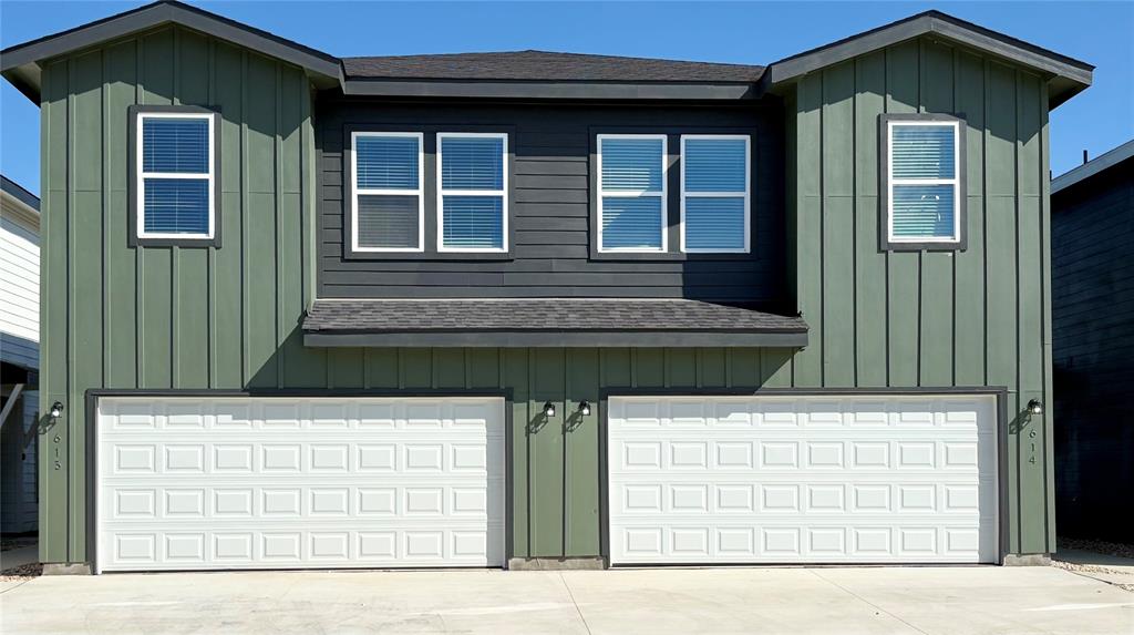 a front view of a house with garage