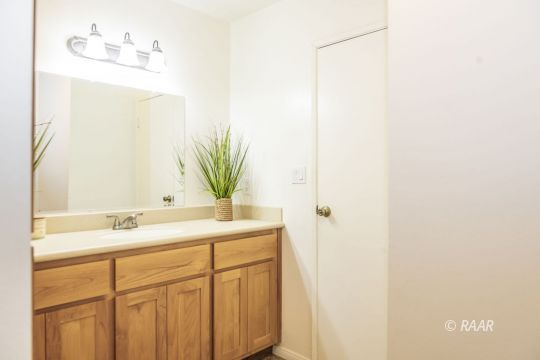 437 Peg Street Ridgecrest, CA 93555 - Photo 16 of 35 a bathroom with a sink and a mirror