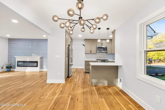 a view of a kitchen with a sink cabinets and wooden floor