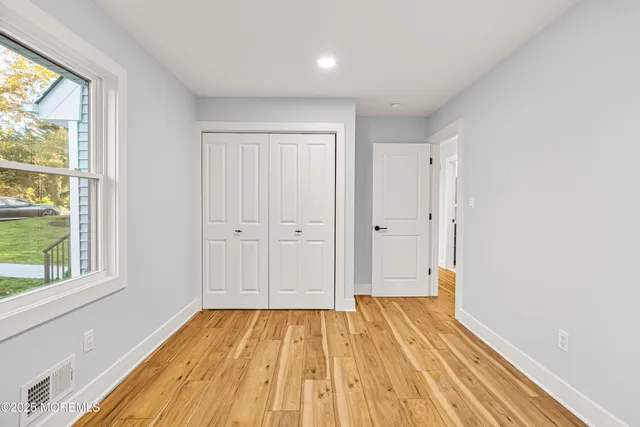 a view of a room with wooden floor and brick walls