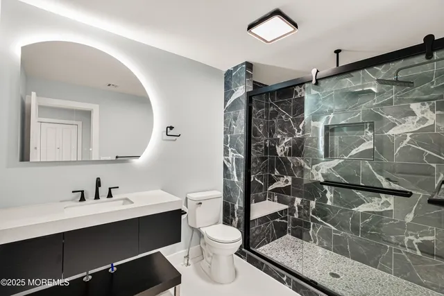 a bathroom with a sink toilet and shower