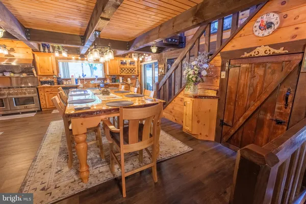 a dining room with furniture and a floor to ceiling window