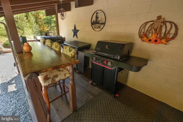 a view of living room kitchen with furniture and wooden floor