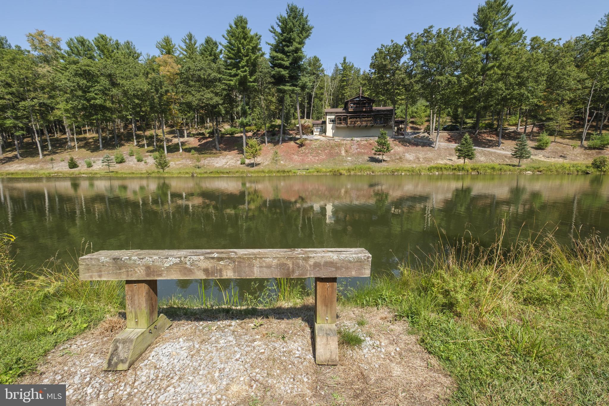 1595 Indian Springs Road Frenchville, PA 16836 - Photo 76 of 86 a view of a lake with a bench next to a lake