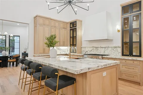 a living room with furniture a fireplace and a chandelier