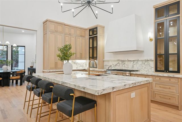 a living room with furniture a fireplace and a chandelier