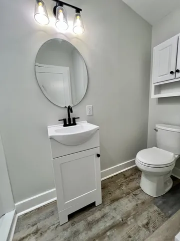 a bathroom with a sink a mirror and a toilet