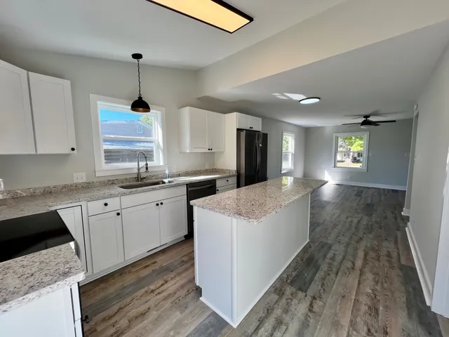 a large kitchen with a stove a sink dishwasher and a refrigerator
