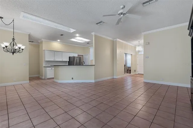 a kitchen with granite countertop white cabinets and black appliances