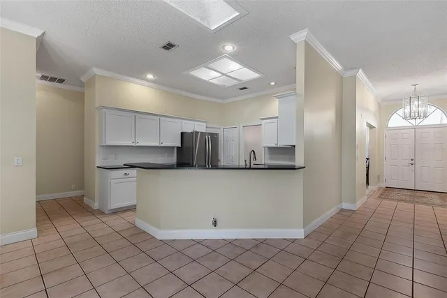 a kitchen with stainless steel appliances a stove sink microwave and cabinets