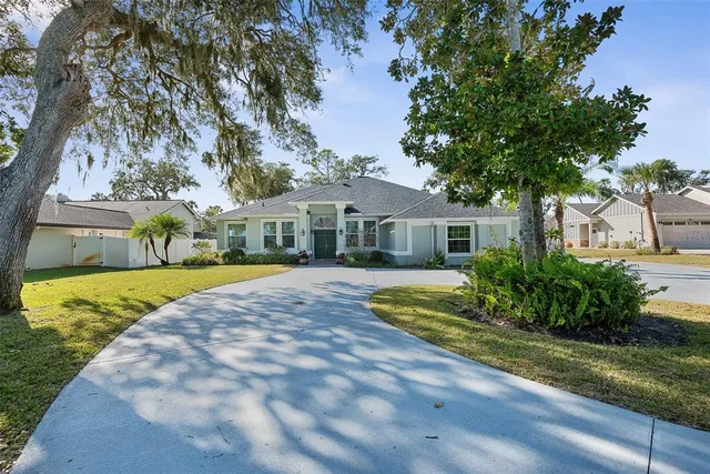 a front view of a house with a yard and potted plants