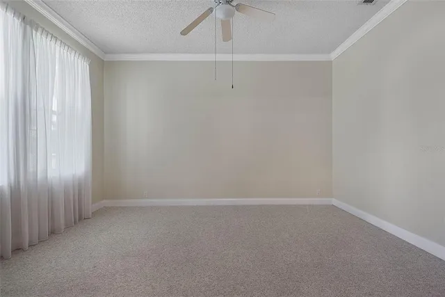 a view of an empty room with cabinet and a flat screen tv