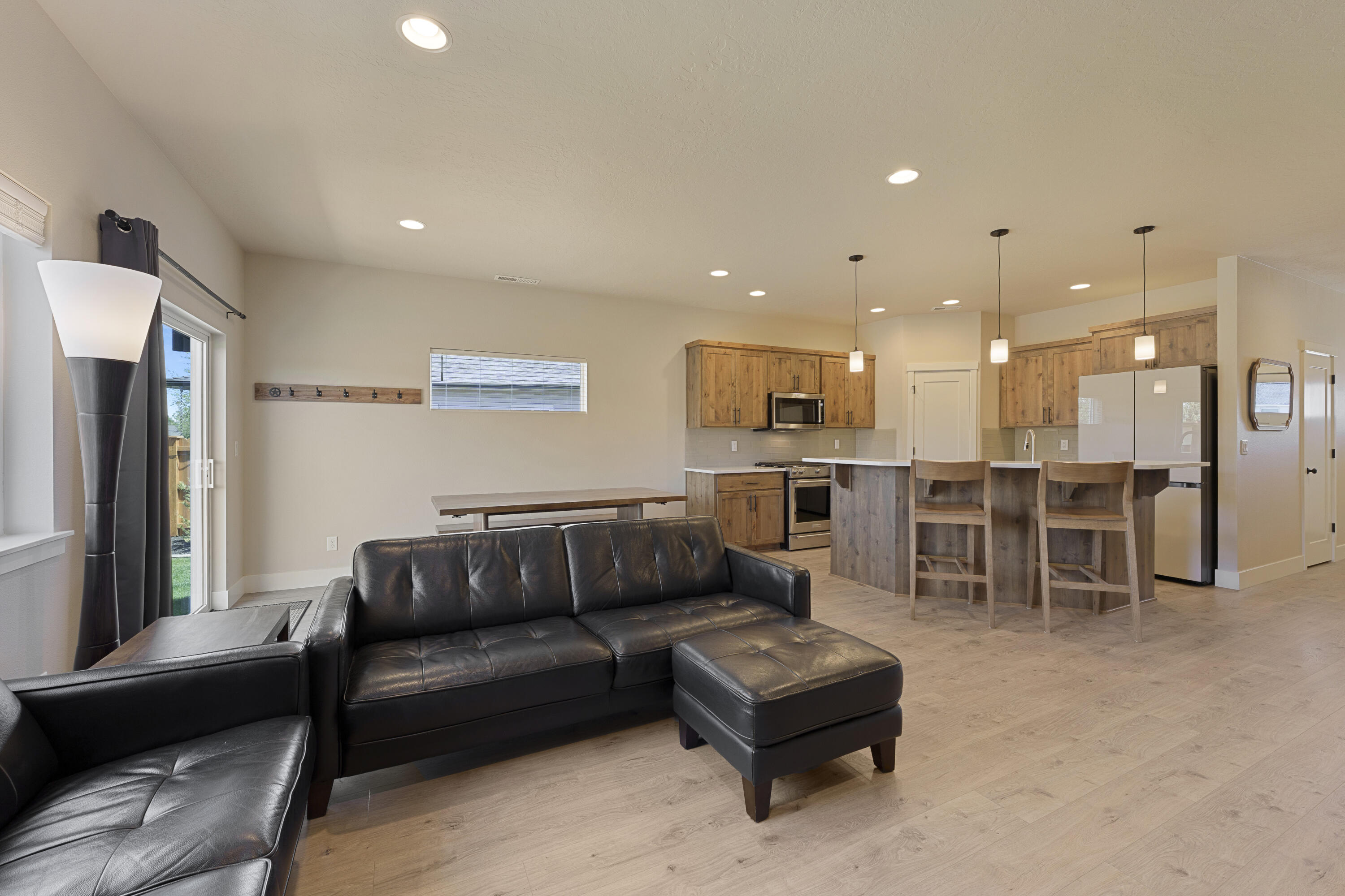 4999 Southwest Yew Place Redmond, OR 97756 - Photo 18 of 50 a living room with furniture and kitchen view