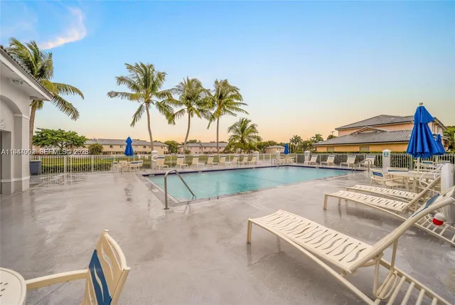 a view of swimming pool with outdoor seating and lake