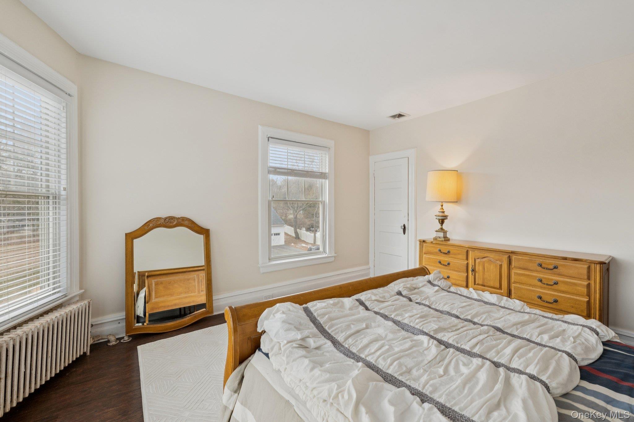 397 Split Rock Road Syosset, NY 11791 - Photo 15 of 29 a bedroom with a bed and a window