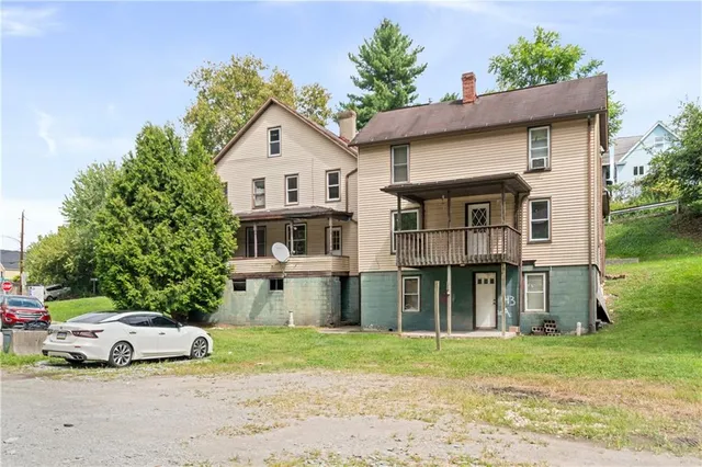 a view of a house with a yard and sitting area
