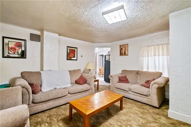 a living room with furniture a couch and a couch