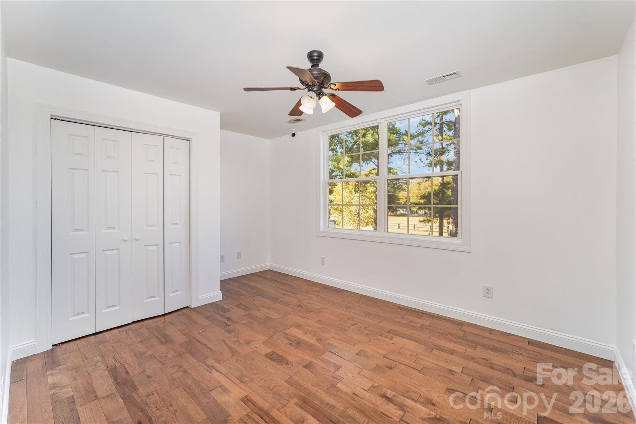 2870 Harmony Road Rock Hill, SC 29730 - Photo 18 of 26 a view of empty room with wooden floor and fan