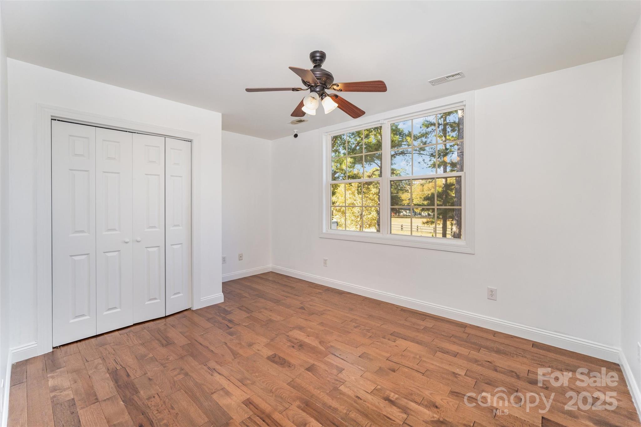 2870 Harmony Road Rock Hill, SC 29730 - Photo 21 of 29 a view of empty room with wooden floor and fan