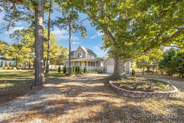 a view of yard with large trees