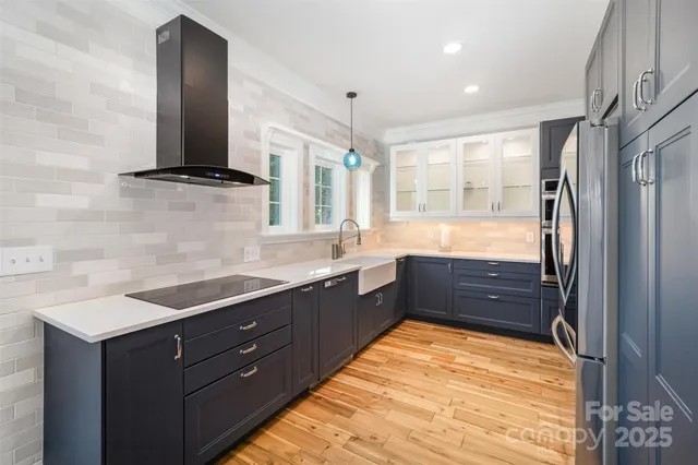 a kitchen with stainless steel appliances granite countertop a refrigerator and a sink