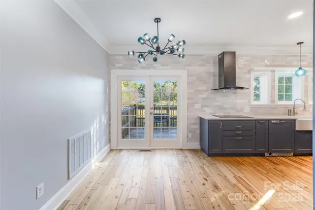 a view of a kitchen with a sink and wooden floor