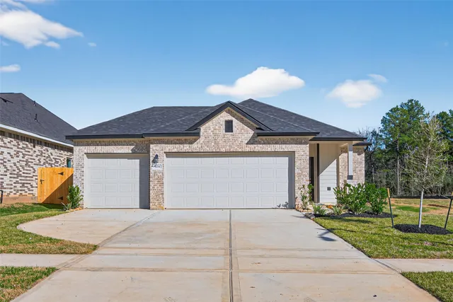 a view of a white house with a yard and plants