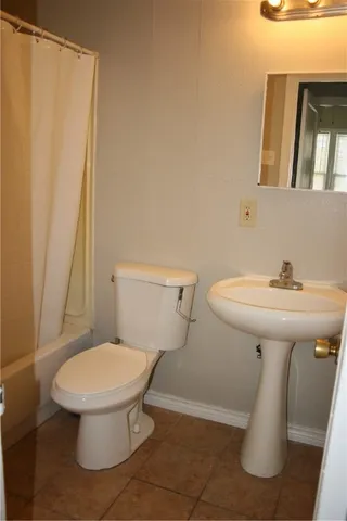 a white toilet sitting next to a bathroom sink