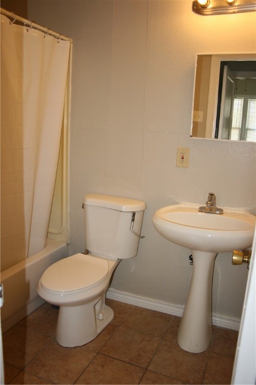814 Ohio Avenue, Unit 2 Corpus Christi, TX 78404 - Photo 6 of 9 a white toilet sitting next to a bathroom sink